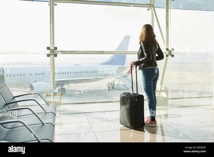 Business Woman in airport talking on the smartphone while walking with hand...