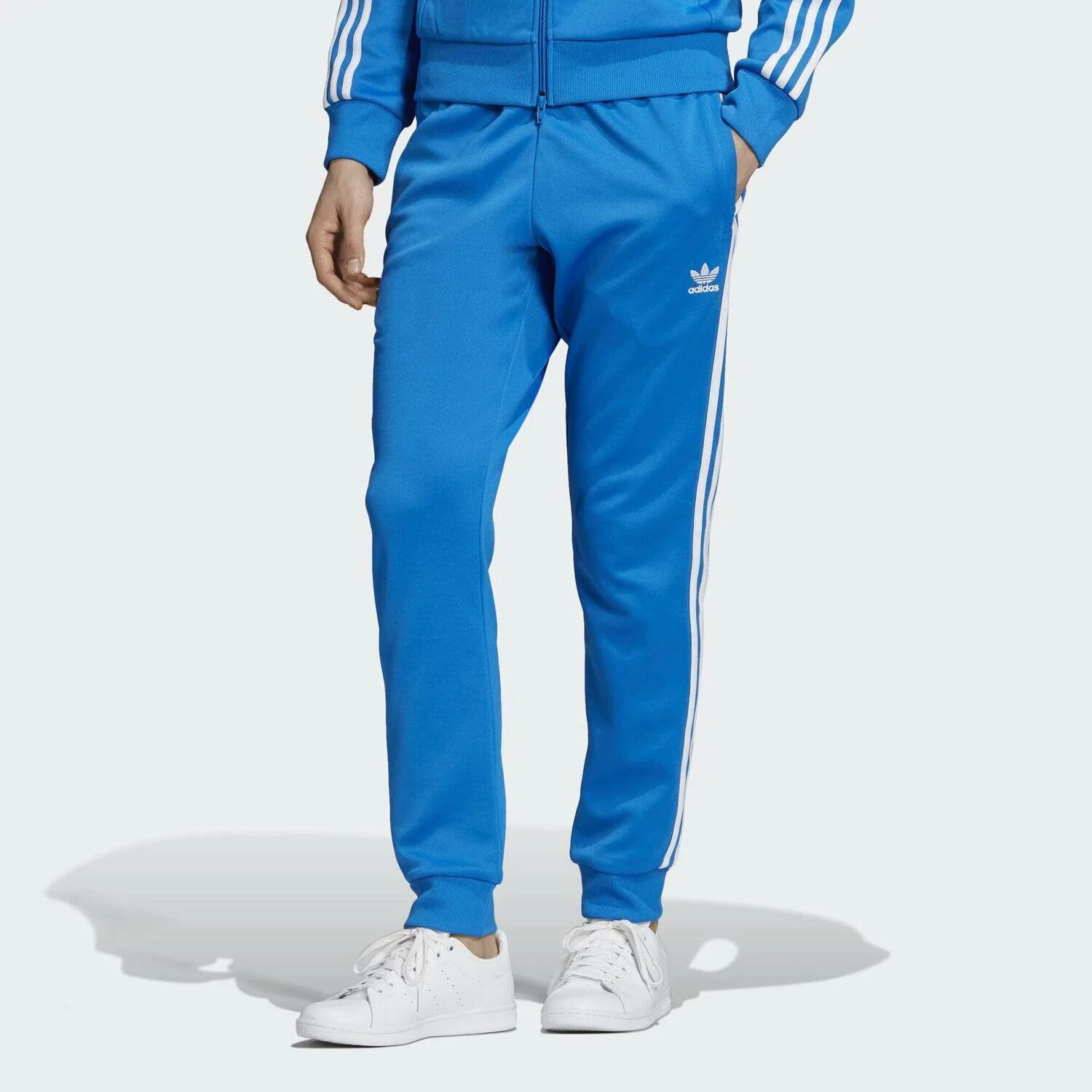 Штаны адидас ориджинал. Адидас Оригиналс брюки SST. Adidas SST TP Blue брюки. Штаны адидас синие Ориджиналс.