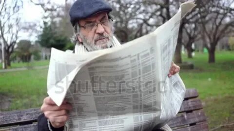 He is reading a newspaper now