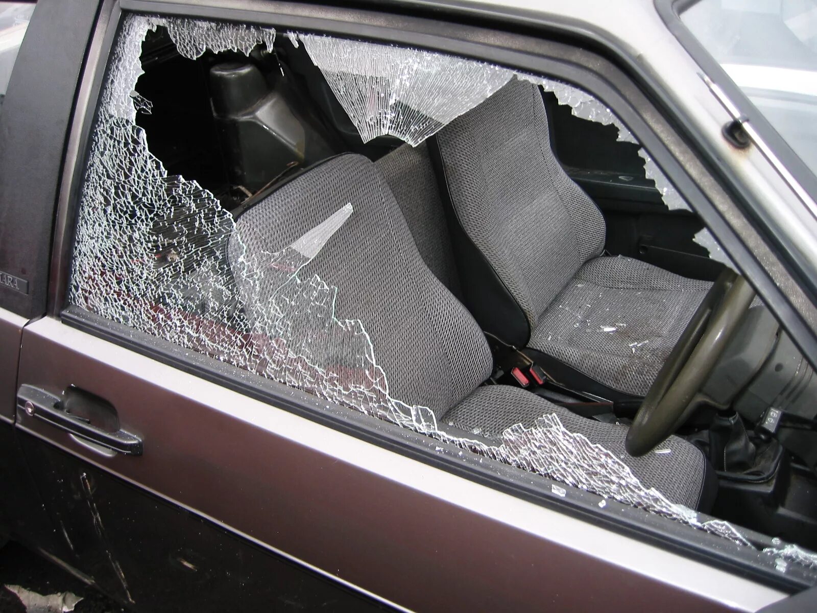 Разбиты окна машин. Разбитое окно машины. Разбивает стекло авто. Разбить окно автомобиля. Разбитое водительское стекло.
