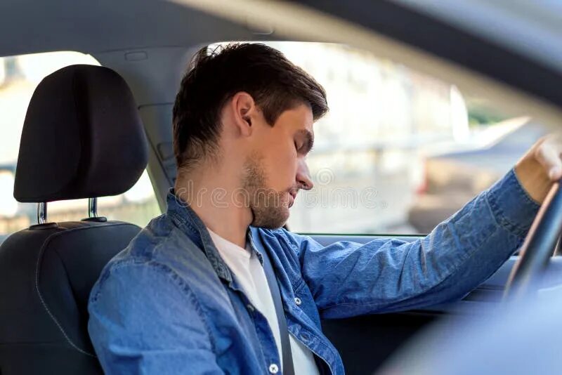 A driver is in the car. Driver fell asleep. driver sleeping.