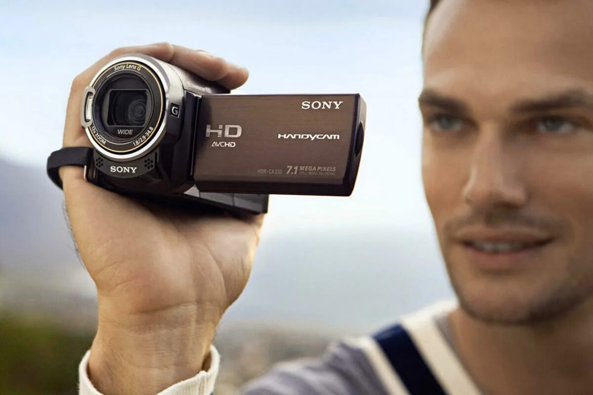 Sony HDR-cx350e. Sony HDR-cx580ve. Видеокамера в руке. Фотоаппарат и видеокамера. Скачай камера man