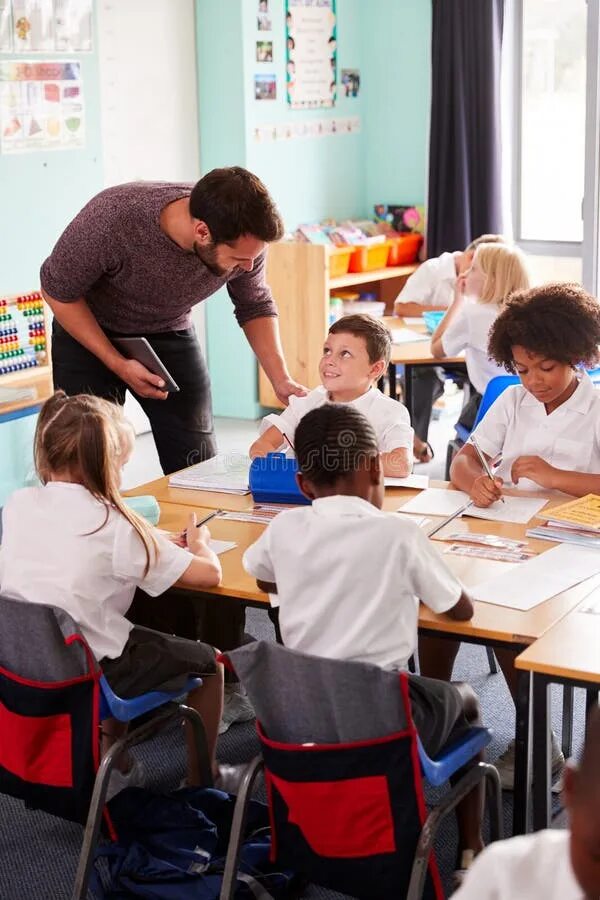 There many pupils in the classroom. School classroom. classroom male teacher. african classroom.
