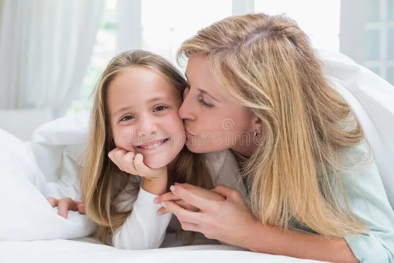 The mother to her daughter. Loving family mother and daughter. Мама целует дочь. The mother to her daughter. The mother to her daughter.