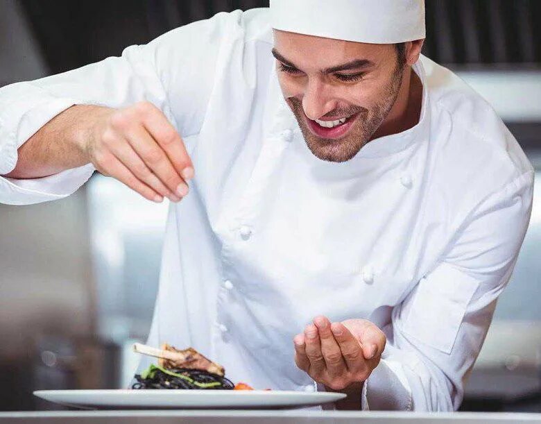 Повар улыбается и показывает пальцем. Cooking like a chef. Повар фото. Cooking like a chef. Amanda freitag.