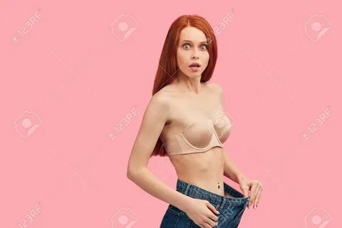 Young skinny anorexic redhead female model with anxious, frightened look, p...