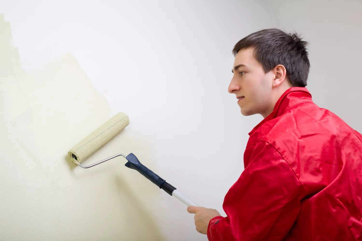 Are the men painting the wall