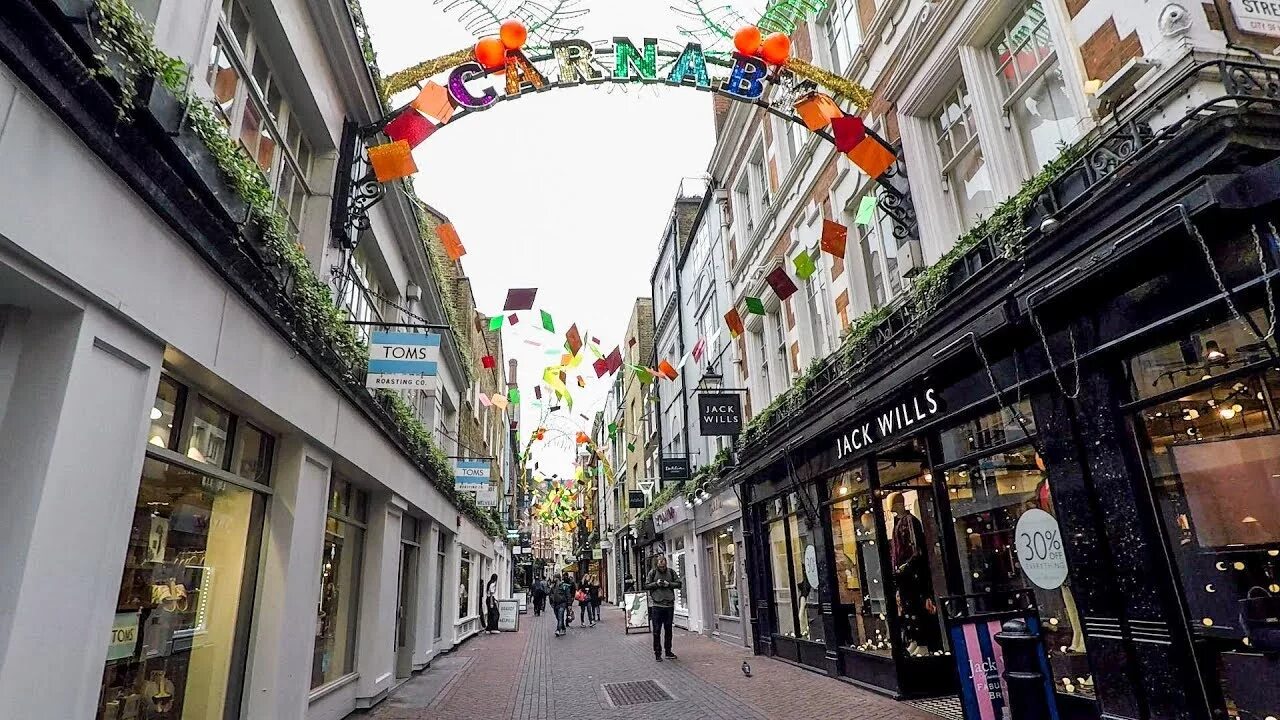 The is located in street. Карнаби стрит Лондон. Оксфорд-стрит в Лондоне. Walking in London. Район Carnaby London вывески.