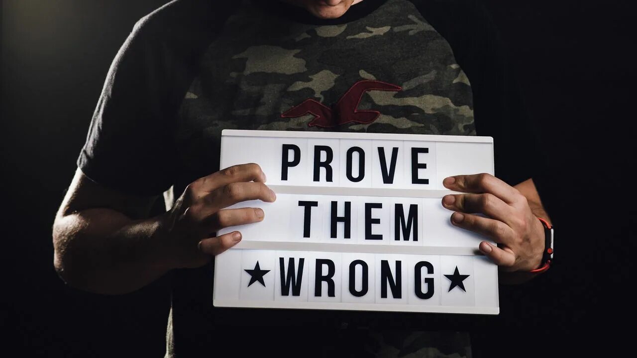 Is to prove that. Prove them wrong. prove them wrong wallpaper. мужик с табличкой в руках.