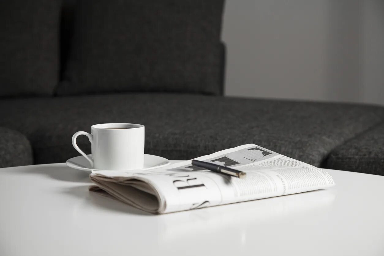 There is a cup on the table. Кофе и газета. Newspaper on the Table. Свежие новости кофе газета ноутубук. Coffee on the Table with newspaper.