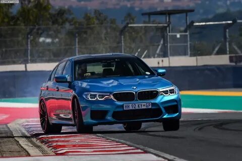 BMW M5, model year 2005-, black, driving, diagonal from the front, frontal  view, test track, Drift, drifting Stock Photo - Alamy