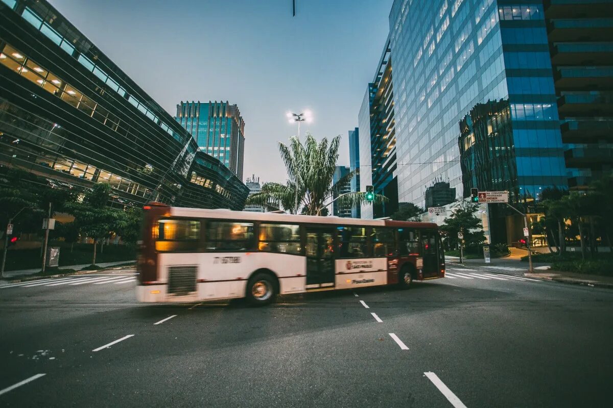 Public transportation. Автобус в городе. Ночной город транспорт. Автобус в городе картинка. Автобус из здания.