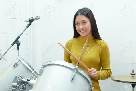 Young Asian Teenage Girl Plays The. asian drummers. 