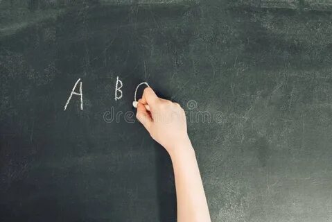 The teacher writes on the blackboard