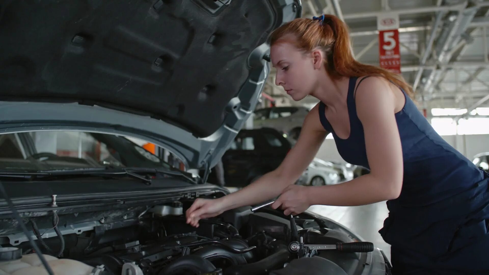 Man fixing car. Car Manufacturing Isuzu. Fix a car. Fixing car woman. She fixes cars