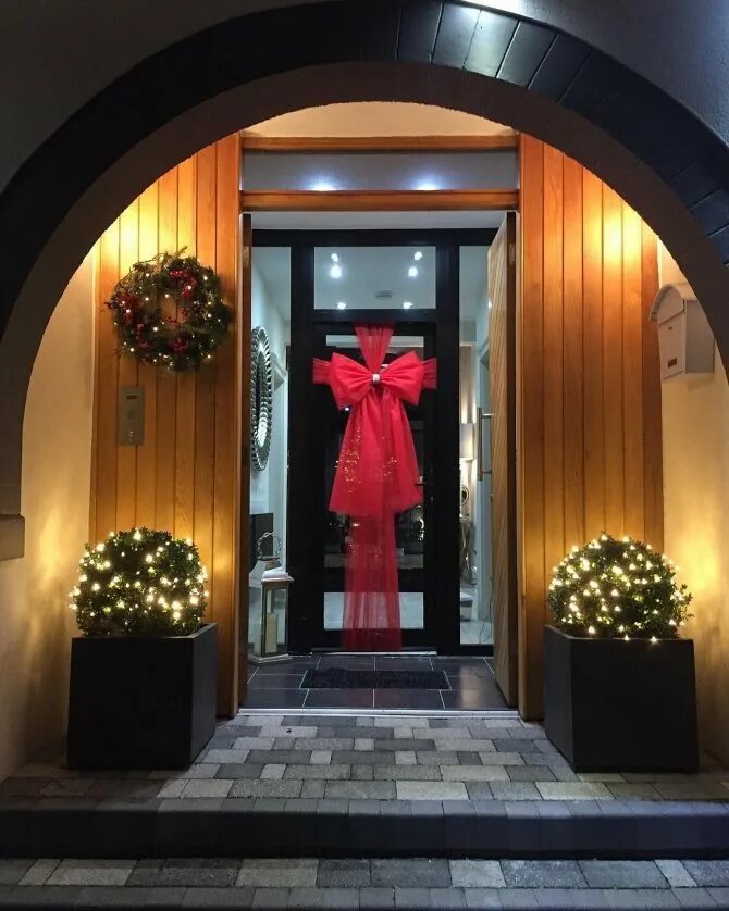 Бант на двери новогодний декор. Большой красный бант. Новогоднее украшение на дверь. Бант на дверь новогодний. Украшение двери бантом.