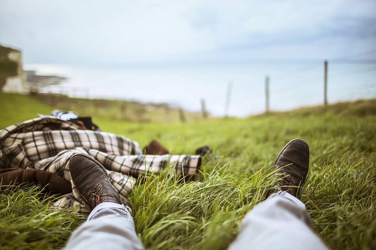 Is sleeping in the garden. Мужчина лежит на траве. Парень лежит на траве. Человек в траве. Мужчина отдыхает на траве.
