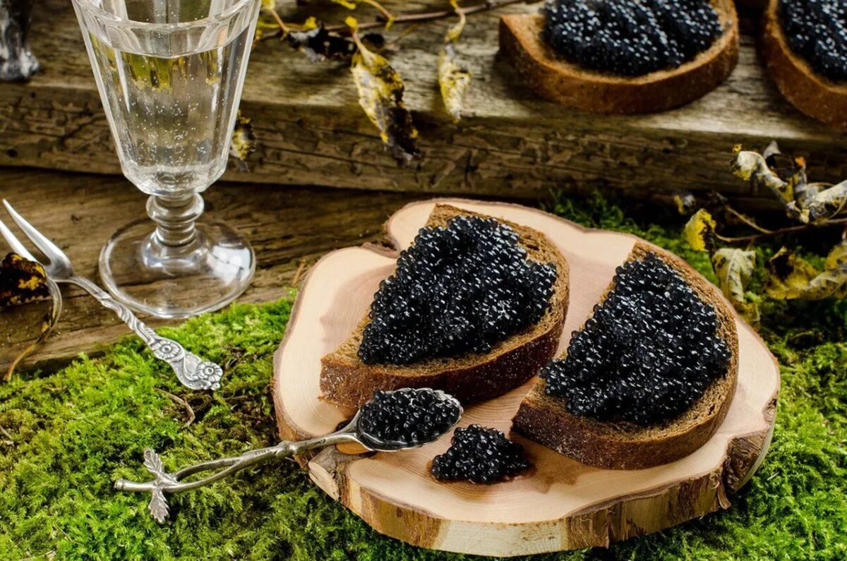 В ней паюсный деликатес 8 букв. Черная икра. Черная икра Caviar. Черная икра на столе. Искры на черном.