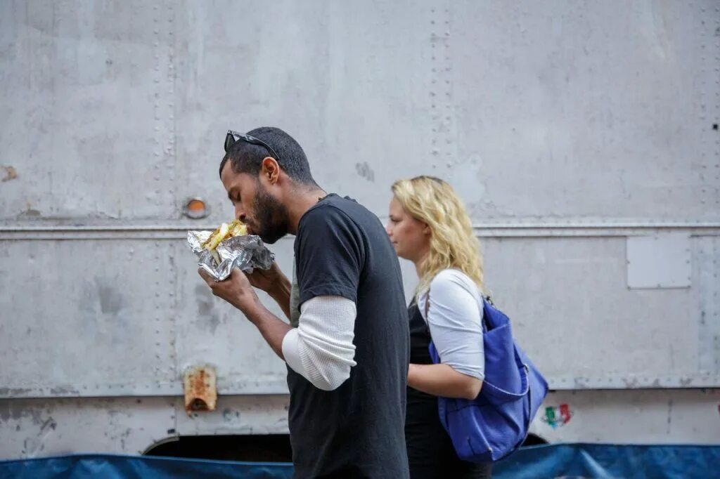 While walking. Business lady is walking along the street. Merbliss walking in newyork. Pedestrians should walk on the pavement. Man walk in the street.