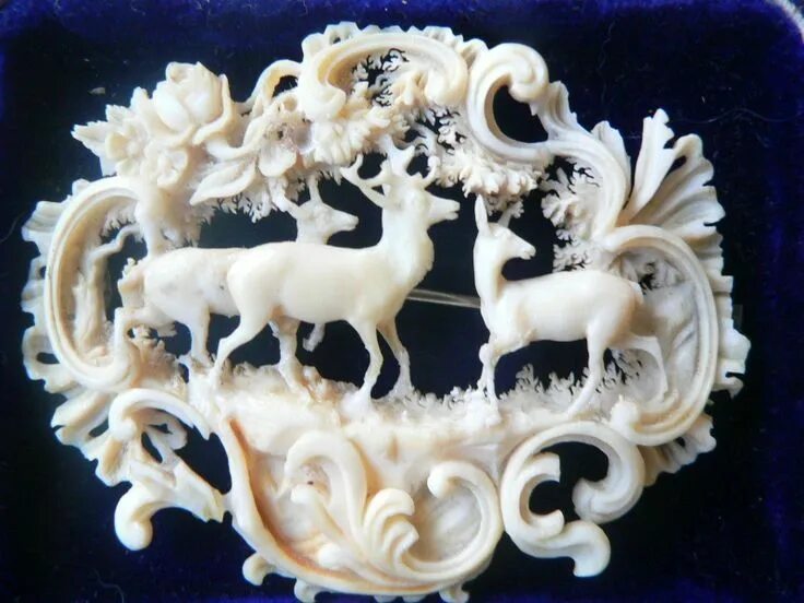 Sold at Auction: A Chinese silvery metal mounted ivory brooch, the
