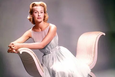 Dina Merrill wearing a silver dress while sitting.