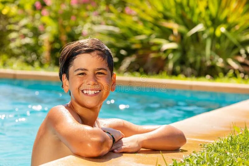 Swimming Pool teenager boy. The boy is in the swimming Pool.