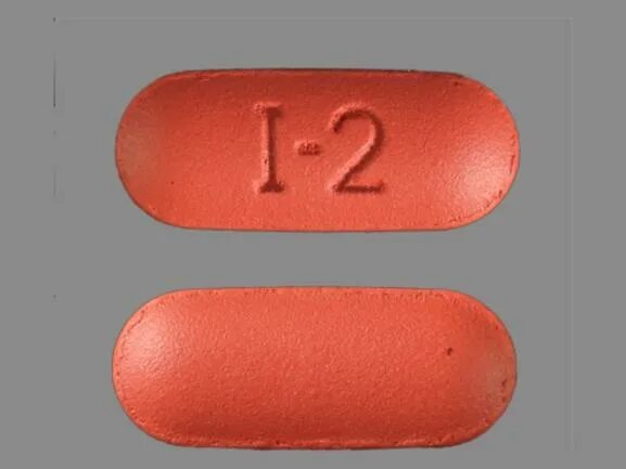 Первая таблетка. Оранжевая овальная таблетка. Красные овальные таблетки. Таблетки оранжевого цвета овальные. Овальные таблетки красного цвета.