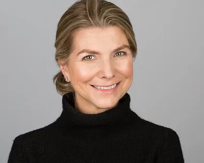 headshot of a middle aged professional lady with her hair tied back.