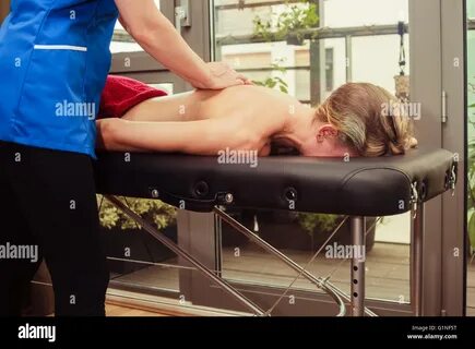 A young woman is getting a massage from a therapist Stock Photo - Alamy.