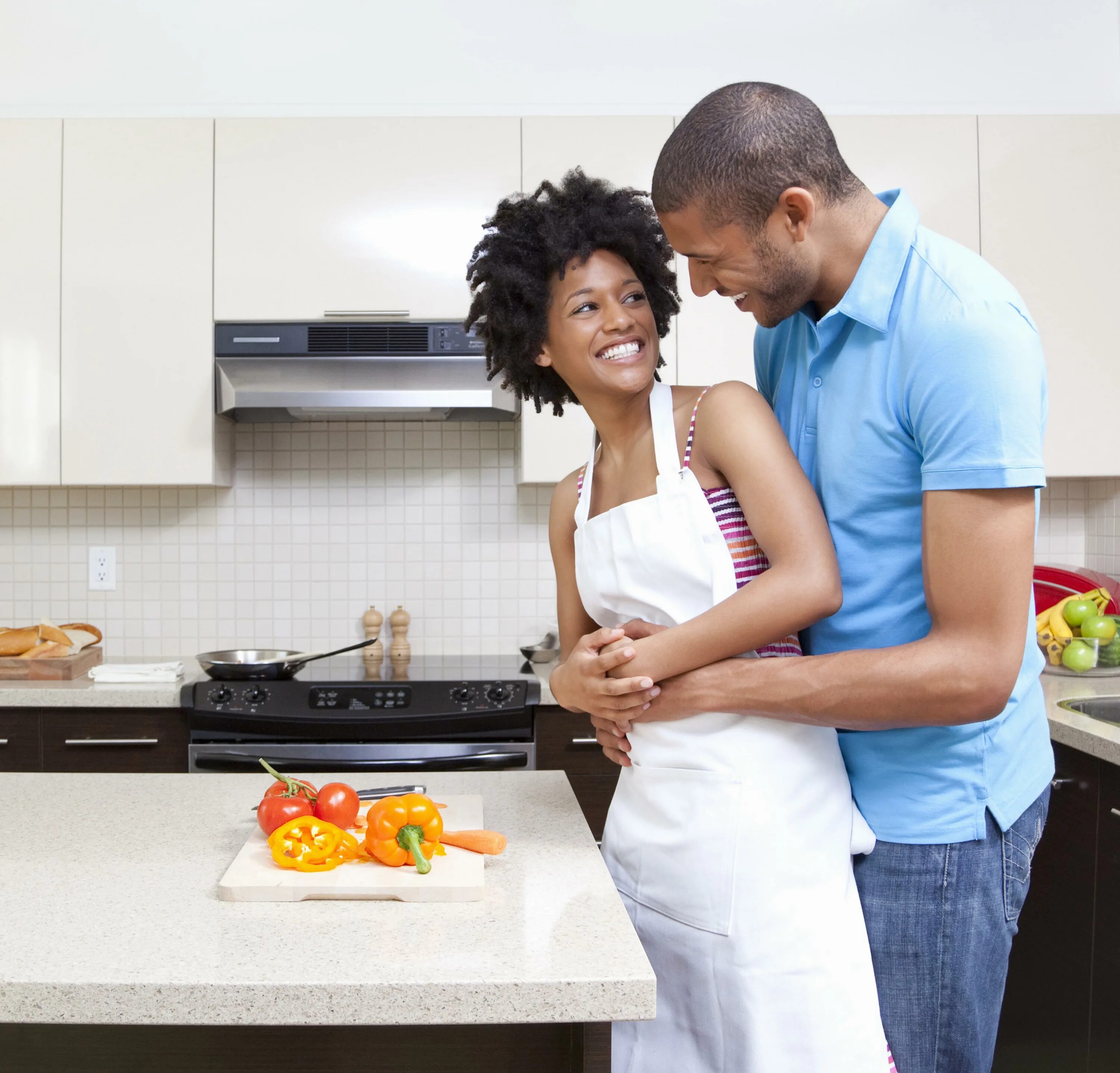 My mother said that she likes cooking. American couple. what was he cooking. kitchen woman stand. american afisant girl.