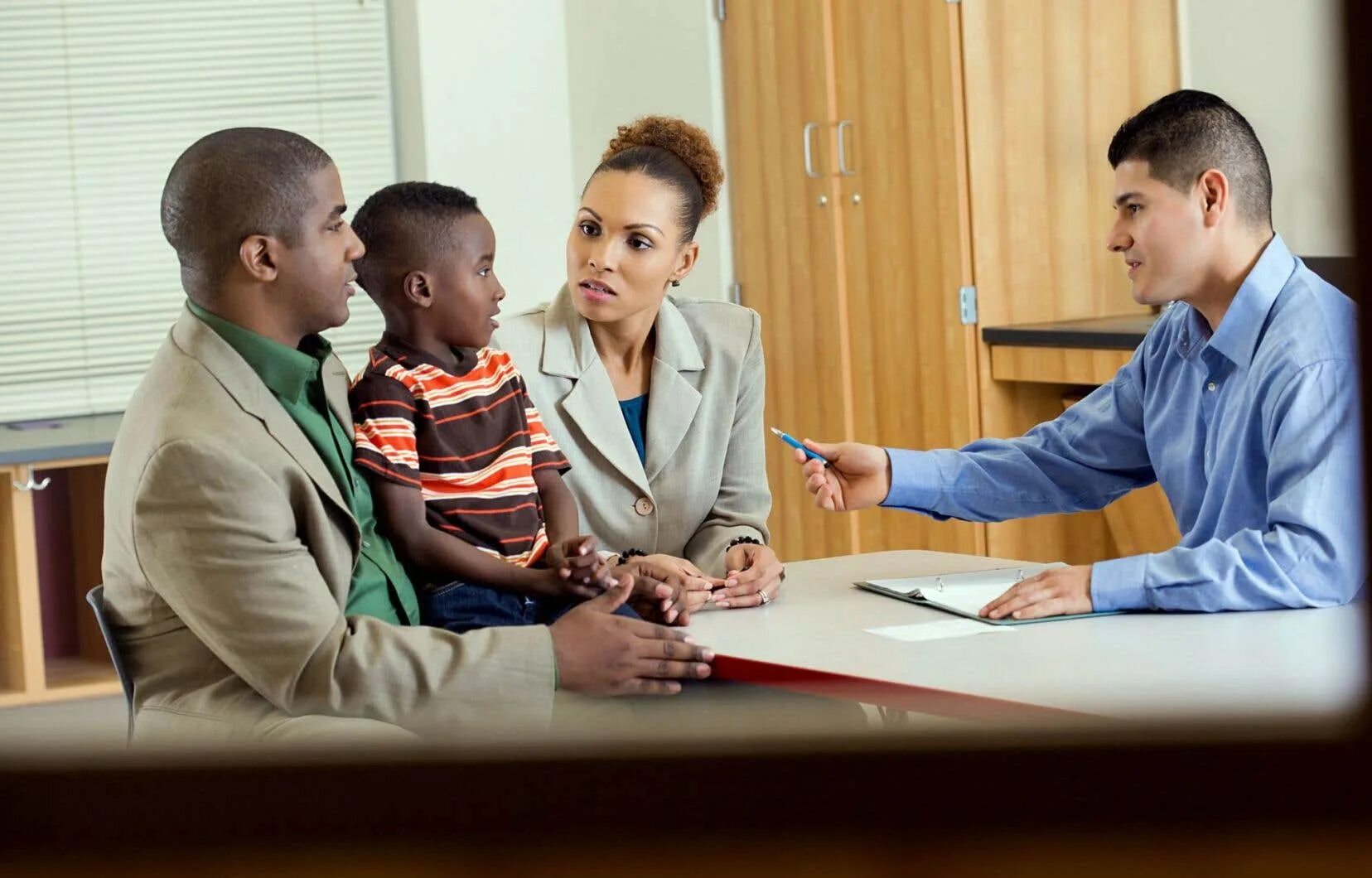 Attending parent. Parent-teacher meeting. parents and teachers. parents with teachers. parents meeting at school.