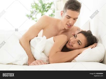 Download high-quality Young couple bed handsome boy wakes his pretty images...