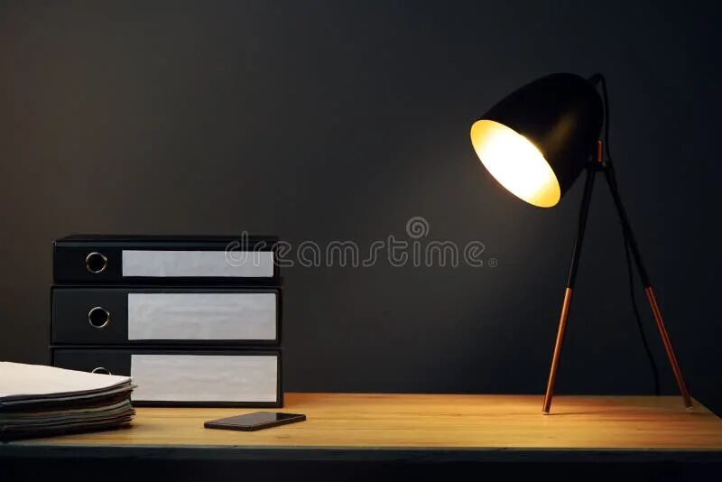 The lamp is on the desk