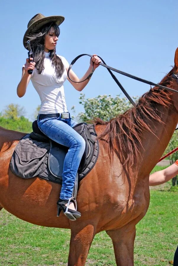 She ride a horse. Конный спорт для детей. Девушка обнимает лошадь. Женщина верхом на игрушечном коне. Дети катаются на лошадях.