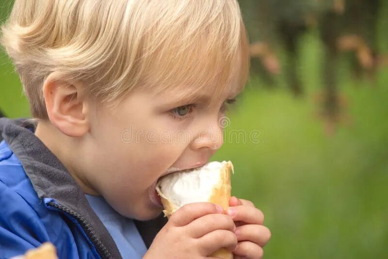 Ест кончину. Мальчишки едят мороженое. Мальчик ест мороженное. Мальчик ест мороженое зимой. Картинка мальчик ест мороженое.