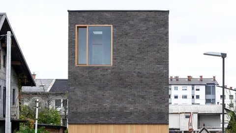 A narrow site in Ljubljana has become home to The Double Brick House