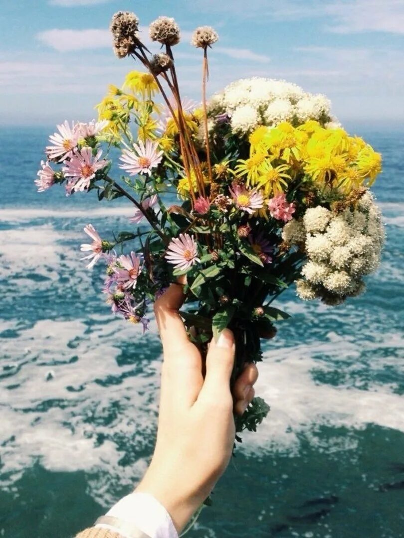Букет цветов счастье. Девушка море цветы. Букет цветов и море. Букет цветов на фоне моря. Букет в руках.