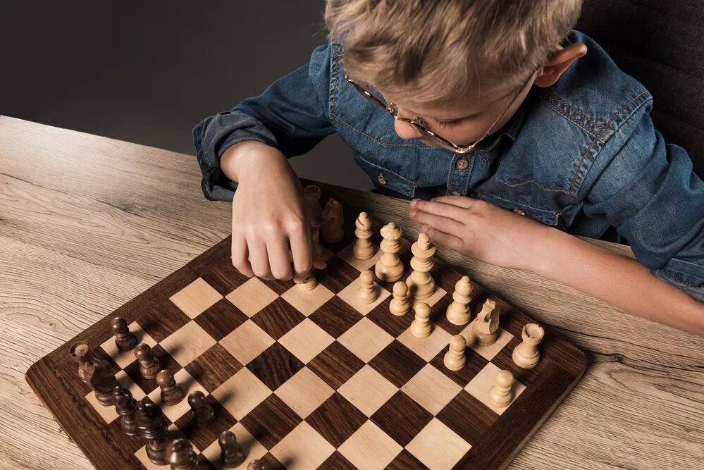 They are playing chess. Boy chess. boy playing chess.