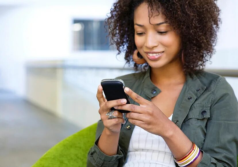 Using user. Женщина со смартфоном. девушка с телефоном на белом фоне. afro american. using phone.