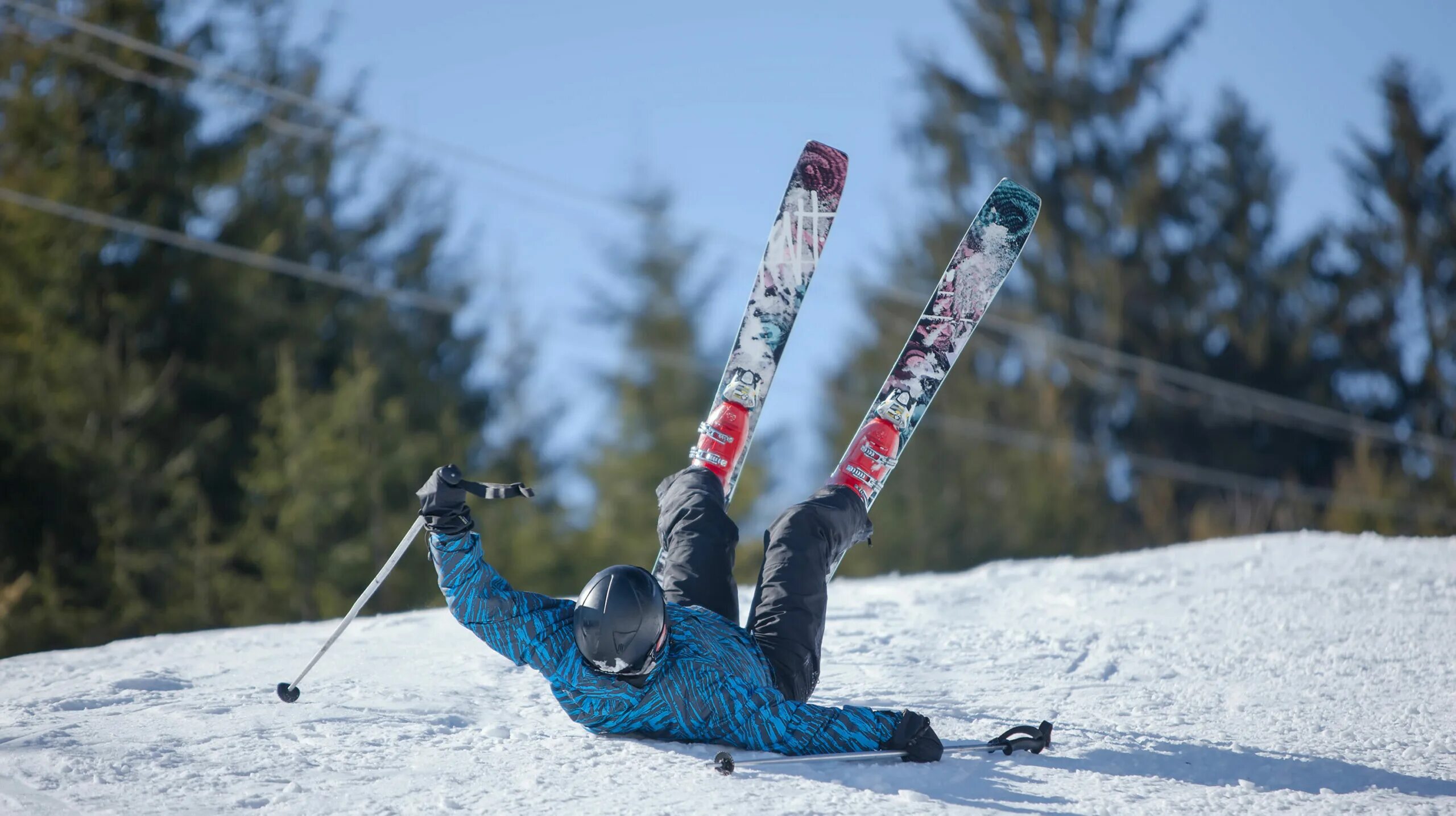 Лыжник падает с горы. Упал на лыжах. Падение на горных лыжах. Лыжник упал.