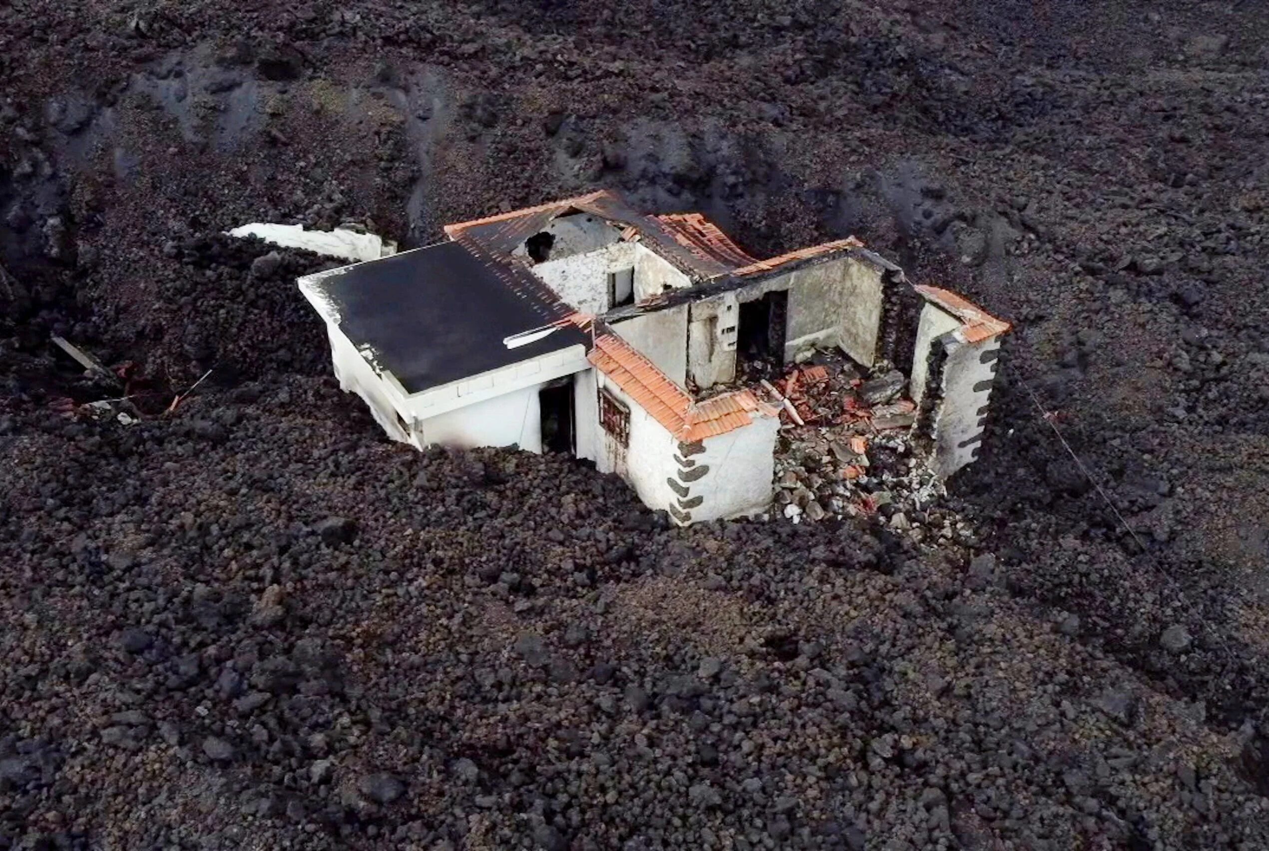 извержение на канарских островах 2021. дом из вулкана. как сейчас выглядит остров после вулкана. стихийные бедствия в испании. земля после извержения вулкана.