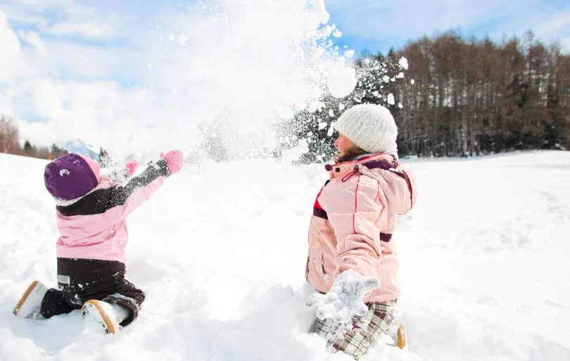 Child playing in the snow. Children playing in the snow. children playing with snow. kids playing in snow. snow child playing.