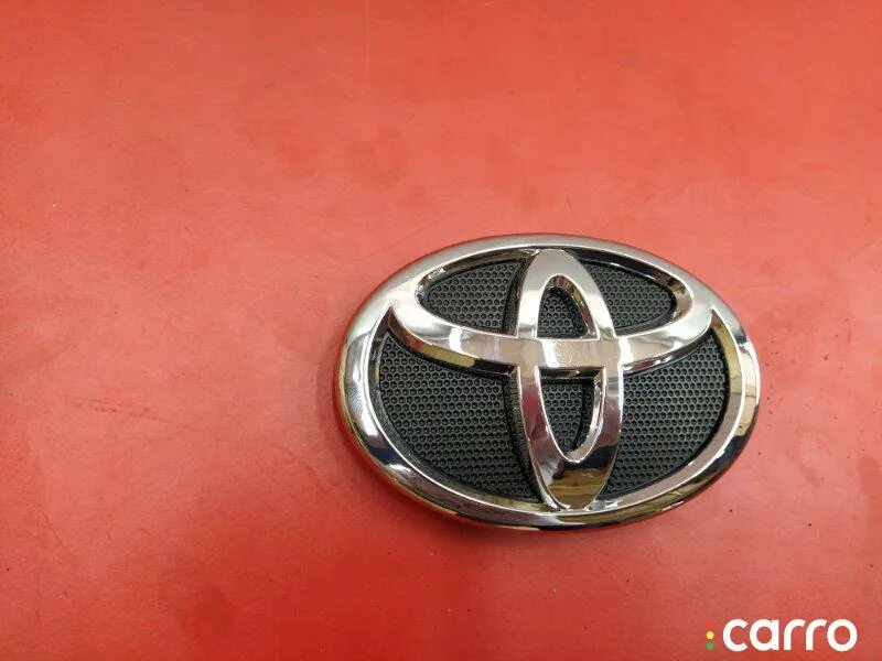 Toyota 7531133130 7531133130 Toyota эмблема решетки радиатора. Передний значок на тойоту Королла 2006г. Значок Тойота Королла 100. Значок Тойота карбон.