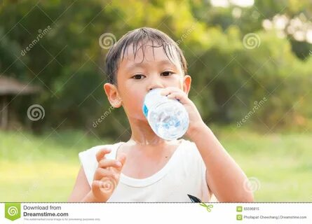 Photo about Asian boy drinking water from plastic bottle after a exercise. 