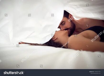 Man And Woman Making Love In Bed.