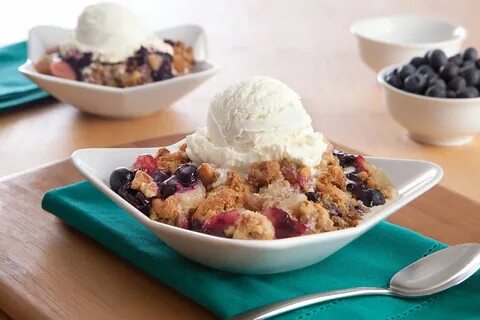 Blueberry cobblers with ice cream and extra blueberries (Getty Images/mitch...