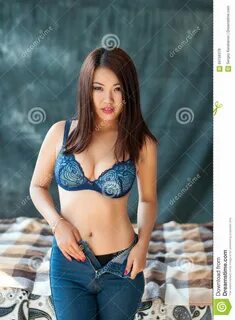 Cute Asian Female In Bra Removes Jeans Stock Photo - Image of female, limge...