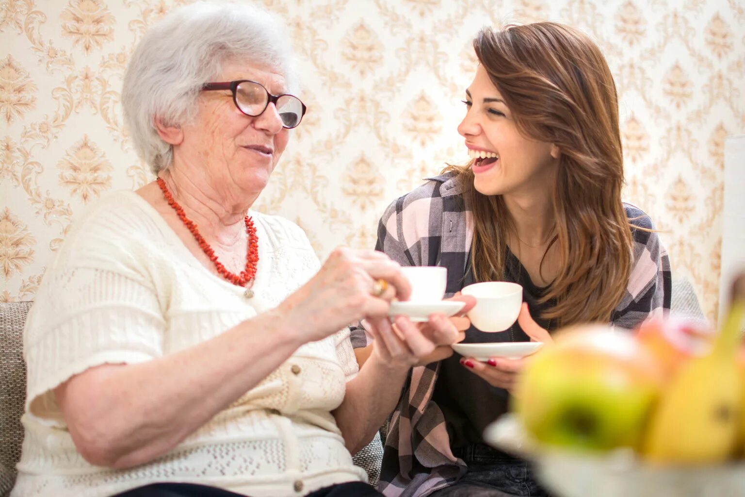 Женщина в своем доме с чашкой. Grandma drinking Tea back shot. Grandma Shutterstock photos.