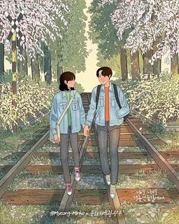 two people walking down train tracks with trees and flowers in the backgrou...