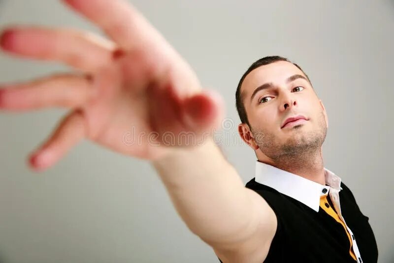 Reach man. Man reaching something. a man looking straight ahead. guys helping hand.